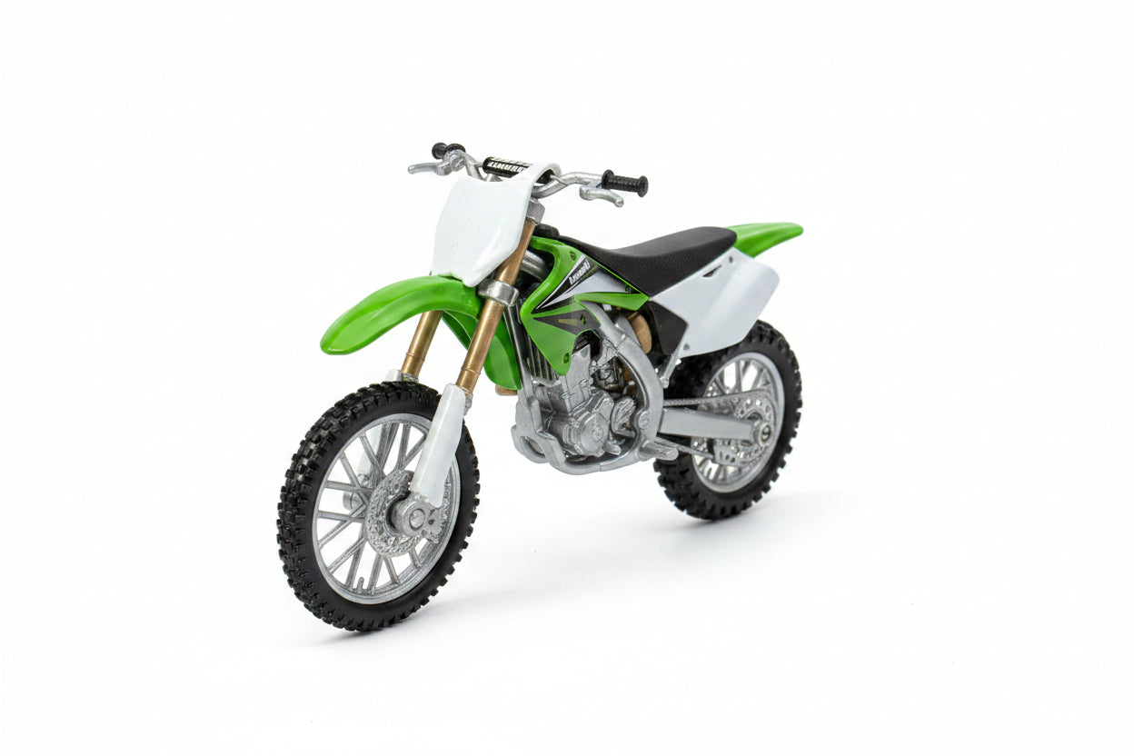 A metal toy motocross bike in its original blue and orange packaging, featuring a green and white dirt bike with silver and black details.
