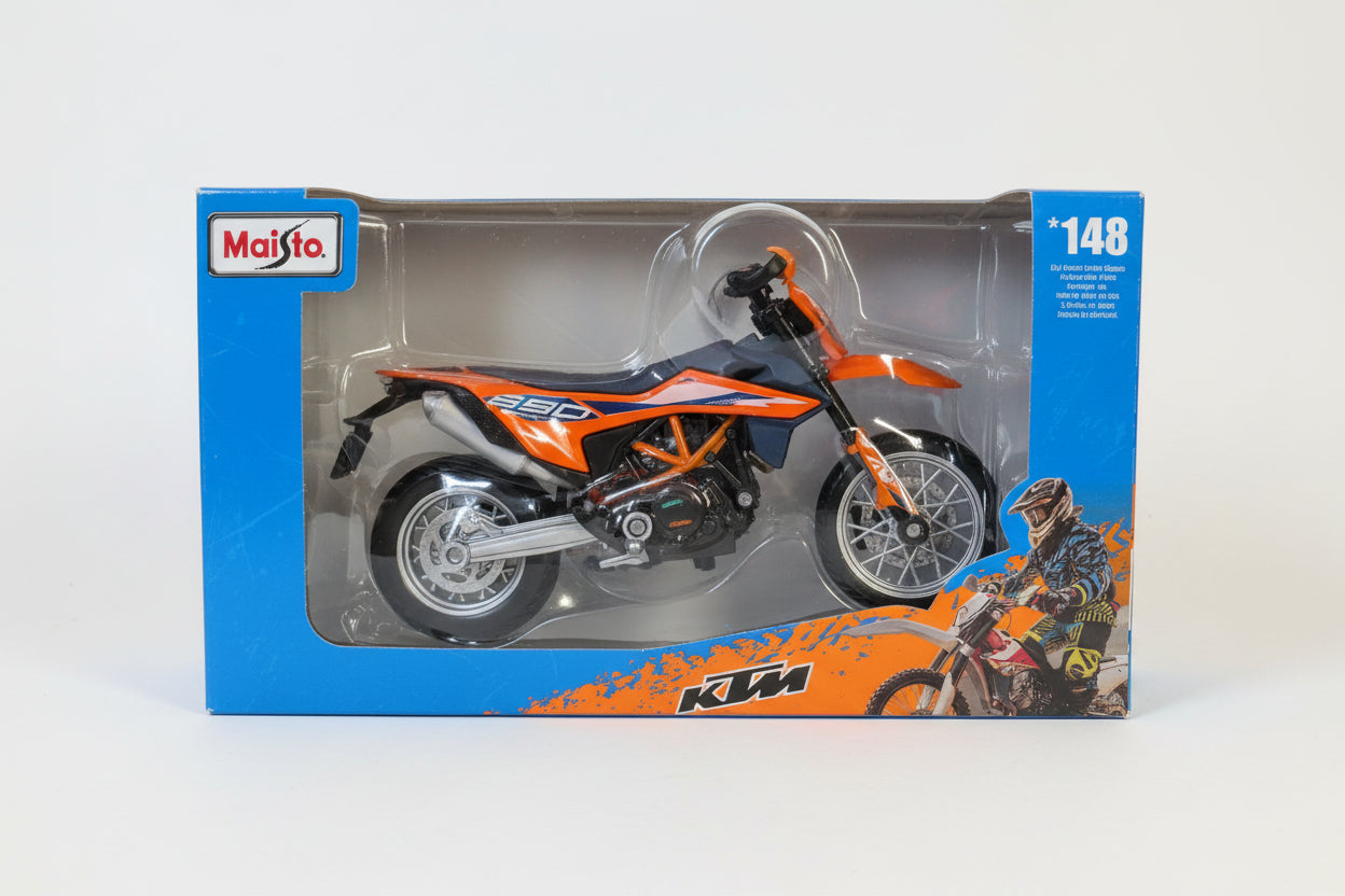A toy motorcycle in its original retail packaging, featuring a blue and orange KTM-themed blister pack with a visible Melco logo.