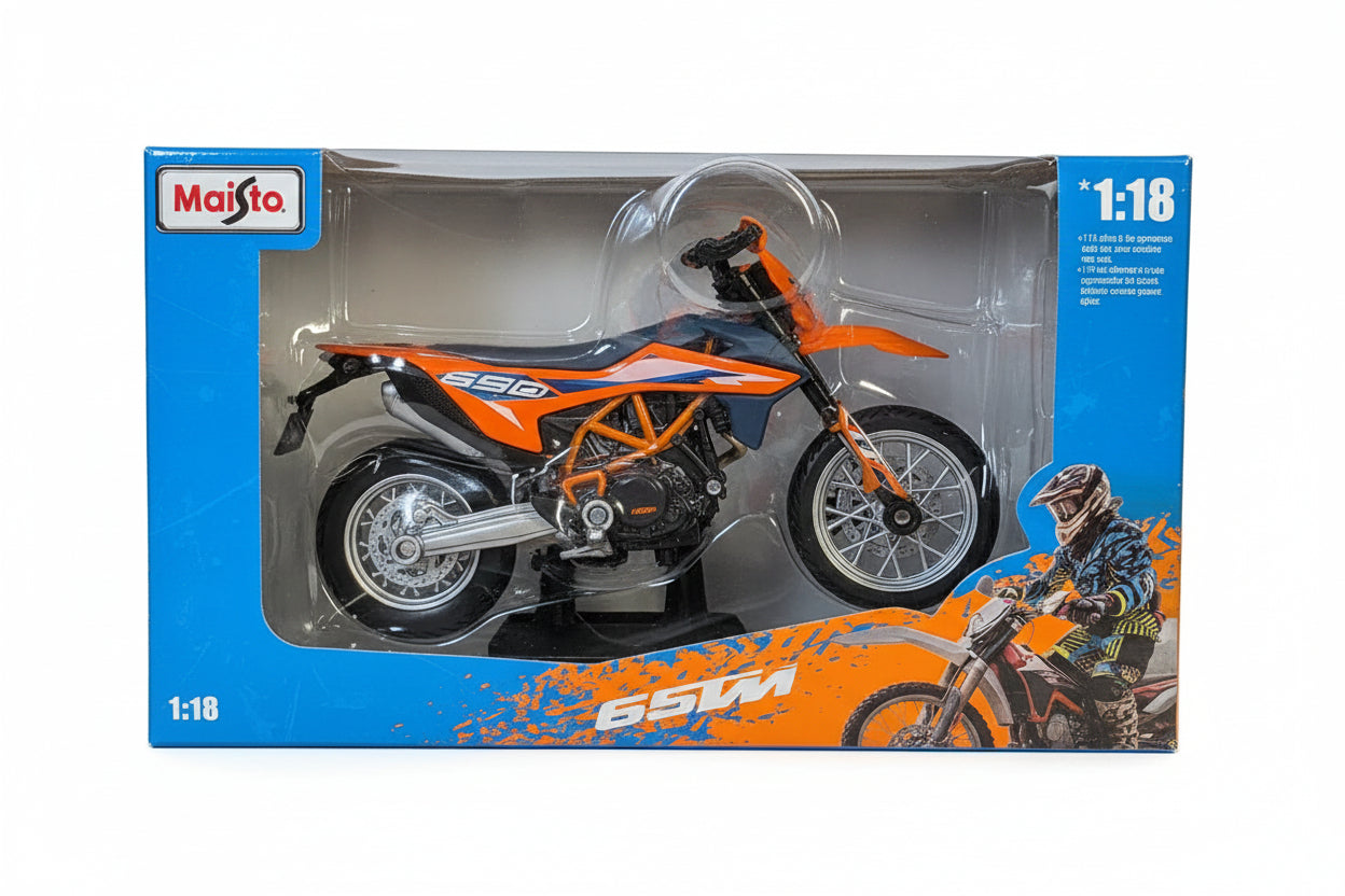 A toy motorcycle in its original blister packaging, featuring a KTM 690 model. The toy bike is orange and black with silver chrome wheels, set against a blue and orange cardboard backing with a clear plastic bubble.